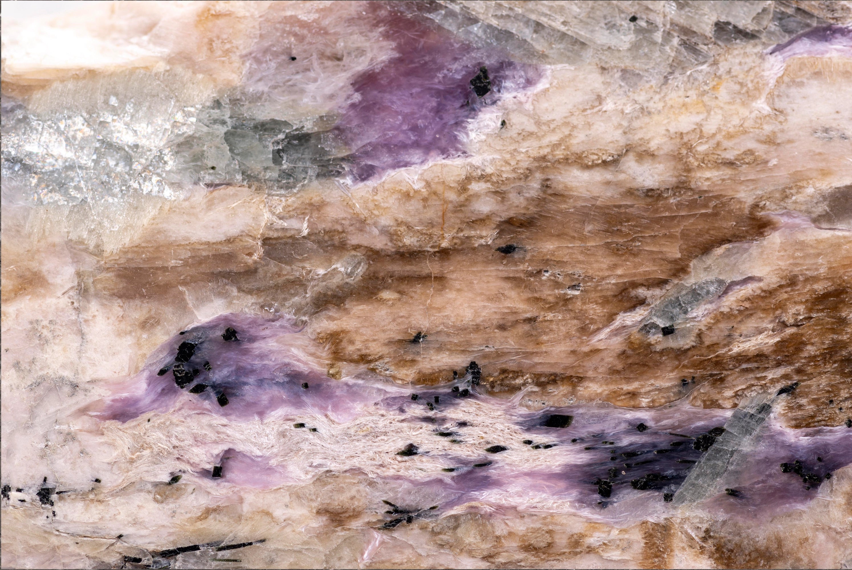 FX ‑ 161 Lavender Strata Marble flexible marble panel showcasing layered cream‑beige and warm taupe striations punctuated by wispy lavender‑purple veins, glimmering silvery crystal pockets, and scattered ebony mineral flecks, by Dunya Home Design.
