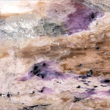 FX ‑ 161 Lavender Strata Marble flexible marble panel showcasing layered cream‑beige and warm taupe striations punctuated by wispy lavender‑purple veins, glimmering silvery crystal pockets, and scattered ebony mineral flecks, by Dunya Home Design.