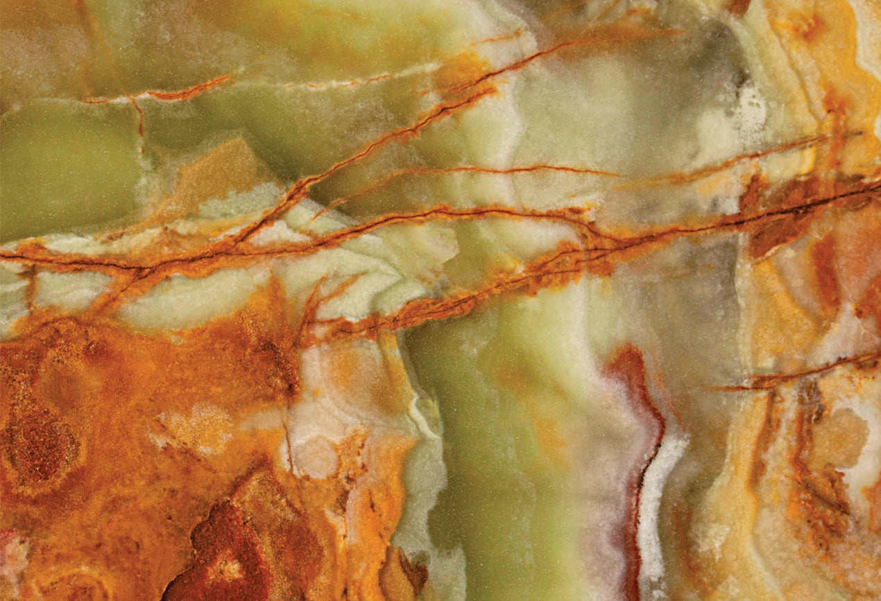 FX‑022 Onice Verde Fiamma flexible marble panel close‑up showing translucent olive‑green base with fiery orange‑red veins and creamy white banding, by Dunya Home Design