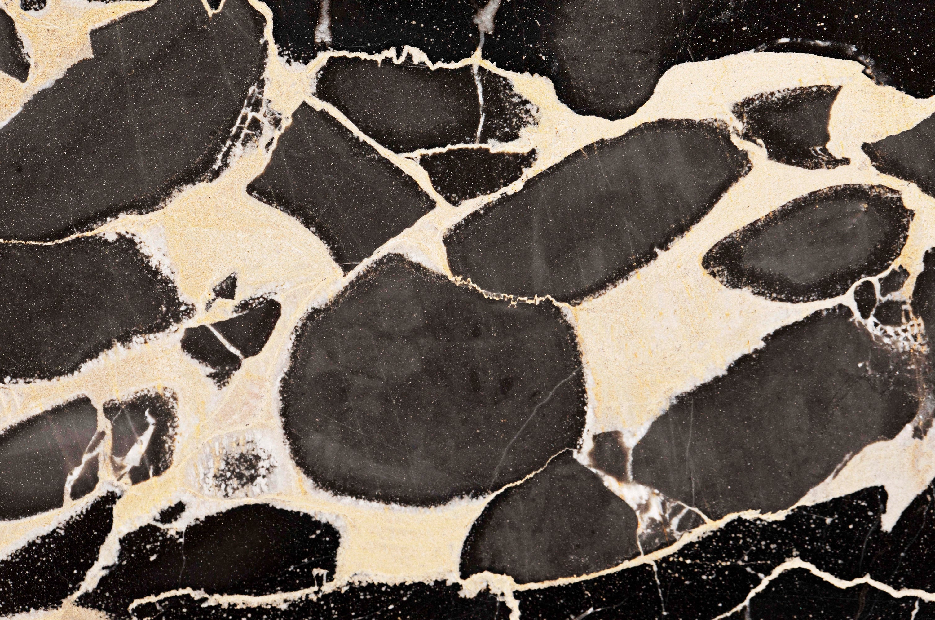 FX‑127 Midnight Pebble Marble flexible marble panel showcasing large irregular midnight-black pebble shapes embedded in a soft cream matrix with fine textural details, by Dunya Home Design.