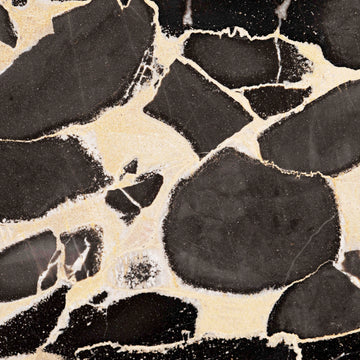 FX‑127 Midnight Pebble Marble flexible marble panel showcasing large irregular midnight-black pebble shapes embedded in a soft cream matrix with fine textural details, by Dunya Home Design.