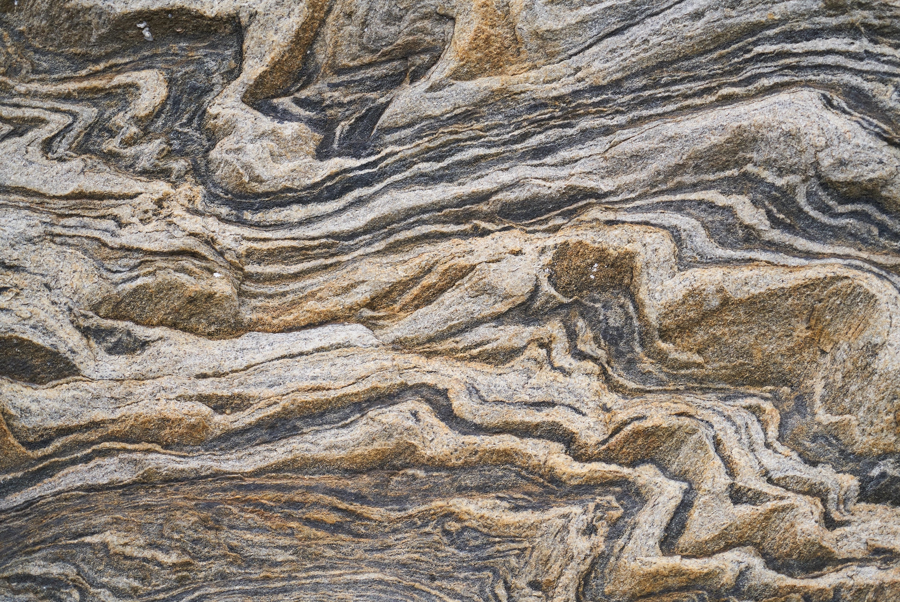 FX‑131 Desert Strata Marble flexible marble panel showcasing swirling layers of sandy beige and charcoal taupe strata with dynamic ribbon patterns, by Dunya Home Design.
