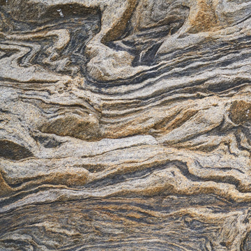 FX‑131 Desert Strata Marble flexible marble panel showcasing swirling layers of sandy beige and charcoal taupe strata with dynamic ribbon patterns, by Dunya Home Design.
