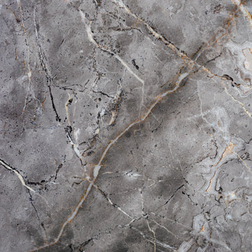 FX‑142 Iron Vein Marble flexible marble panel featuring a cool mid‑grey base streaked with bold white and rust‑orange veins, accented by fine iron‑speckled textures for an industrial yet elegant look, by Dunya Home Design.