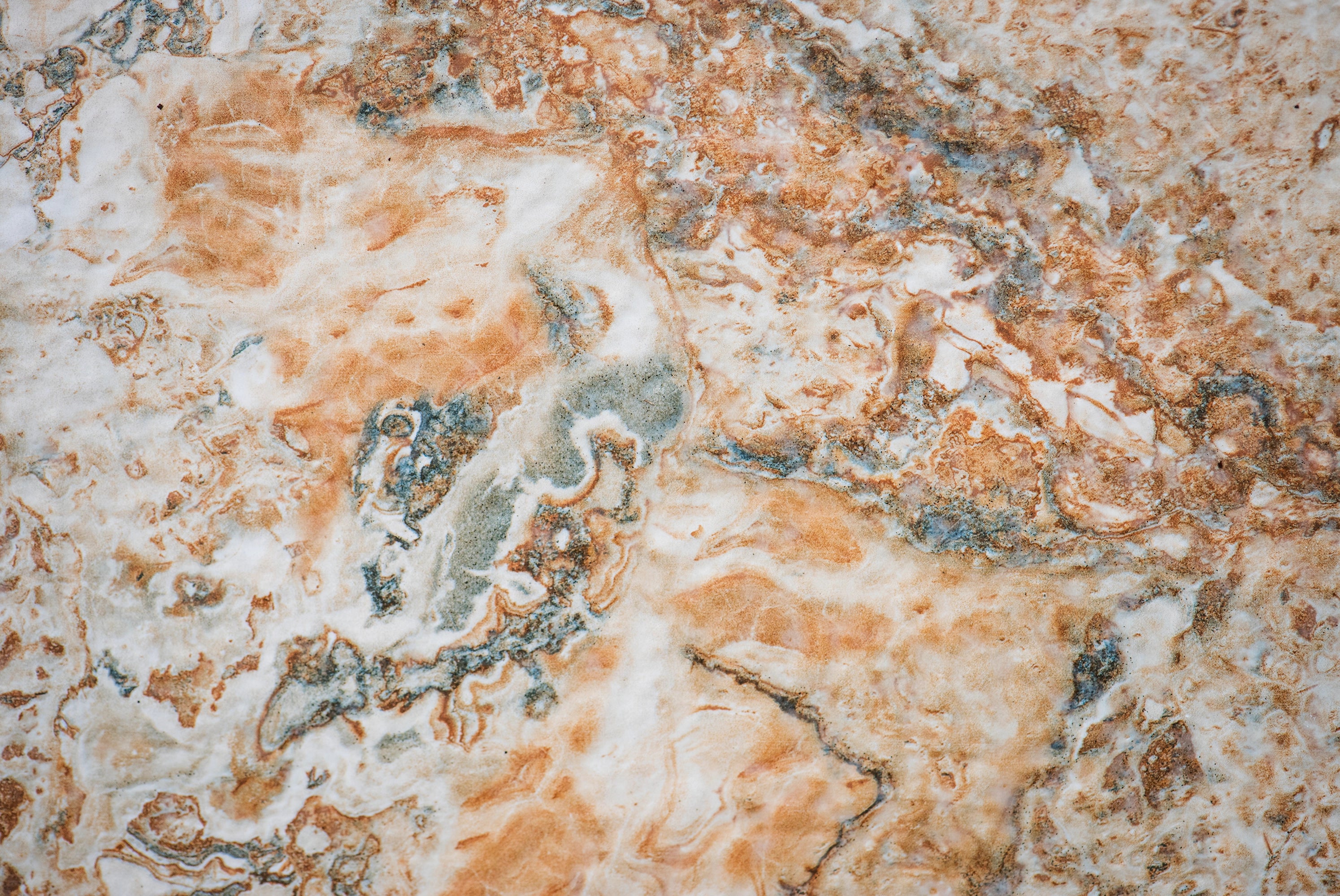 “FX‑147 Rust Tide Marble” flexible panel by Dunya Home Design: an abstract marble pattern in creamy white with swirling patches of rust orange, burnished copper, and silvery gray that blend in fluid, tide‑like currents across the surface.