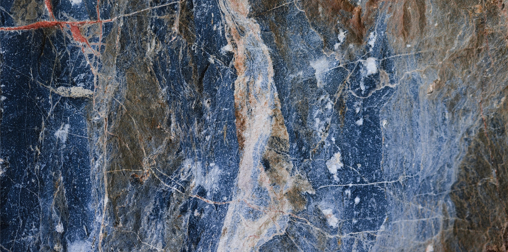 FX ‑ 155 Blue Rust Marble flexible marble panel showcasing a stormy navy‑blue background streaked with warm rust‑orange veins and flecks of white quartz, by Dunya Home Design.