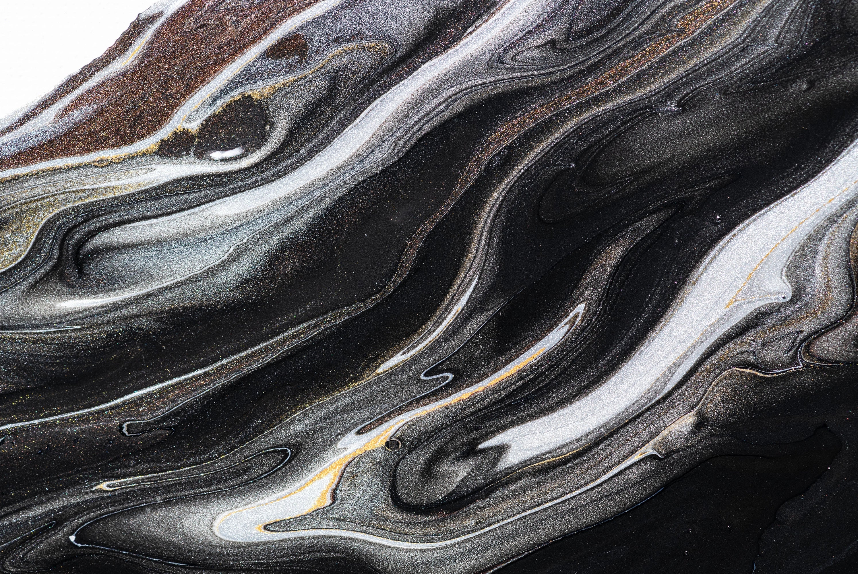 “FX‑152 Obsidian Flow Marble” flexible panel by Dunya Home Design: a dynamic, fluid pattern of swirling deep black base streaked with metallic silver and warm copper‑gold accents, creating a glossy, marble‑like surface with glittering, flowing veins.