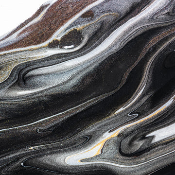 “FX‑152 Obsidian Flow Marble” flexible panel by Dunya Home Design: a dynamic, fluid pattern of swirling deep black base streaked with metallic silver and warm copper‑gold accents, creating a glossy, marble‑like surface with glittering, flowing veins.