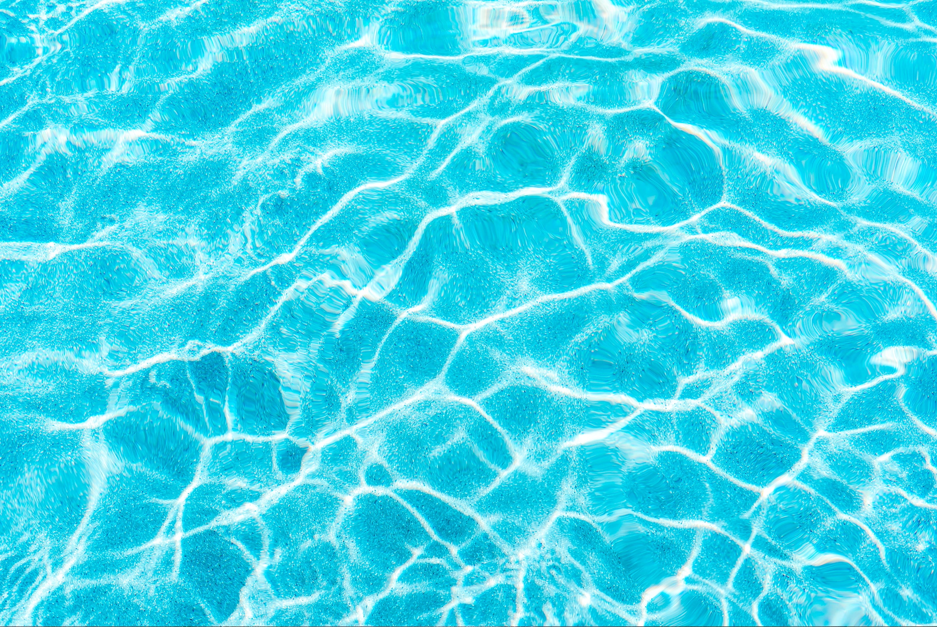 FX ‑ 154 Sunlit Ripples Set flexible marble panel showcasing a sunlit aqua‑blue water surface with shimmering white highlights and gentle, undulating ripple patterns, by Dunya Home Design.