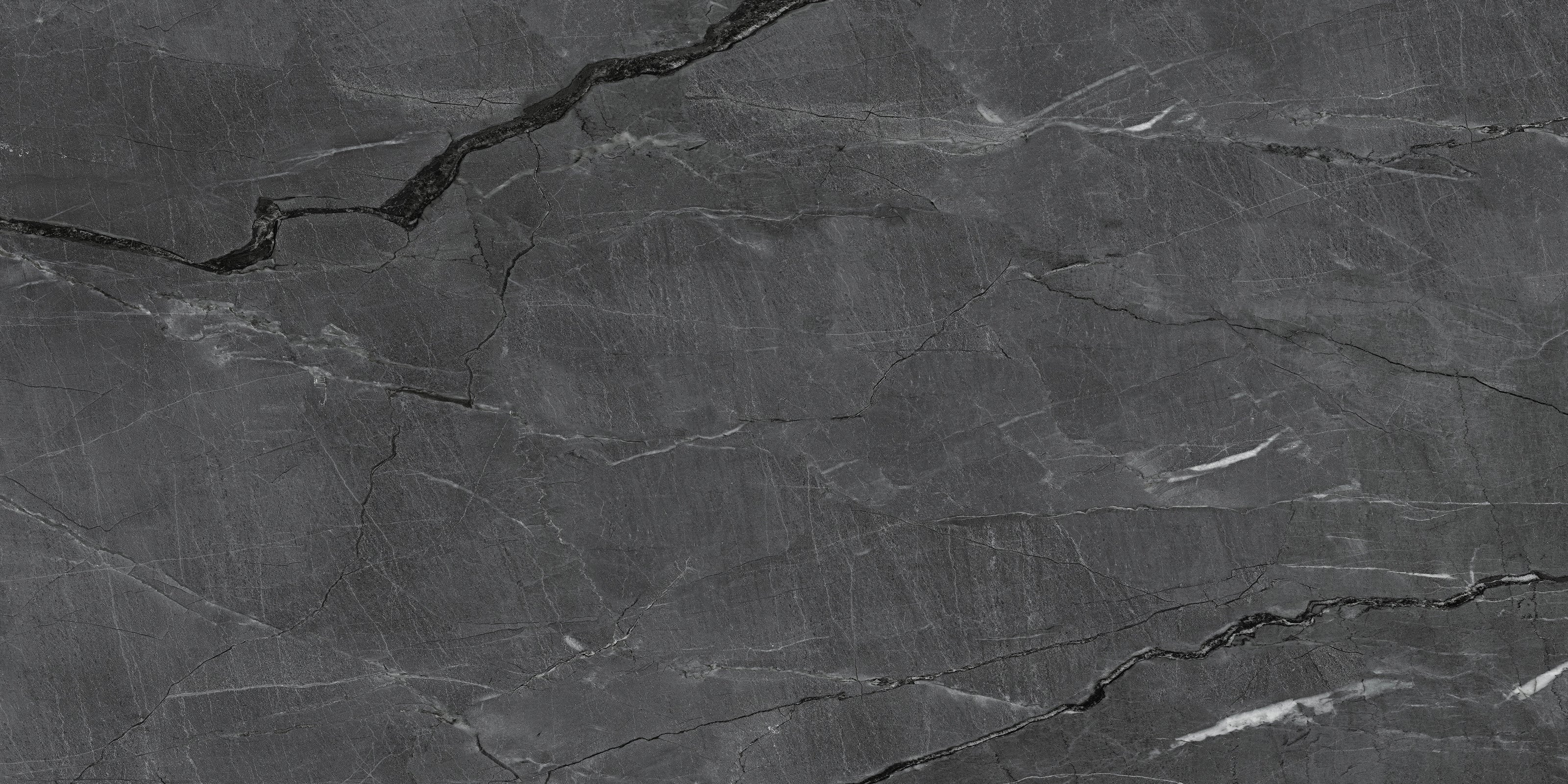 FX‑187 Midnight Rift Set flexible marble panel showcasing a deep charcoal‑black background with subtle slate‑grey texture and striking jagged white and silver-grey fissures that evoke the look of a dramatic nighttime rift, by Dunya Home Design.