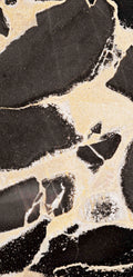 FX‑127 Midnight Pebble Marble flexible marble panel showcasing large irregular midnight-black pebble shapes embedded in a soft cream matrix with fine textural details, by Dunya Home Design.