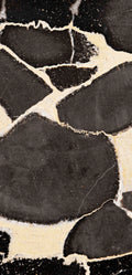 FX‑127 Midnight Pebble Marble flexible marble panel showcasing large irregular midnight-black pebble shapes embedded in a soft cream matrix with fine textural details, by Dunya Home Design.