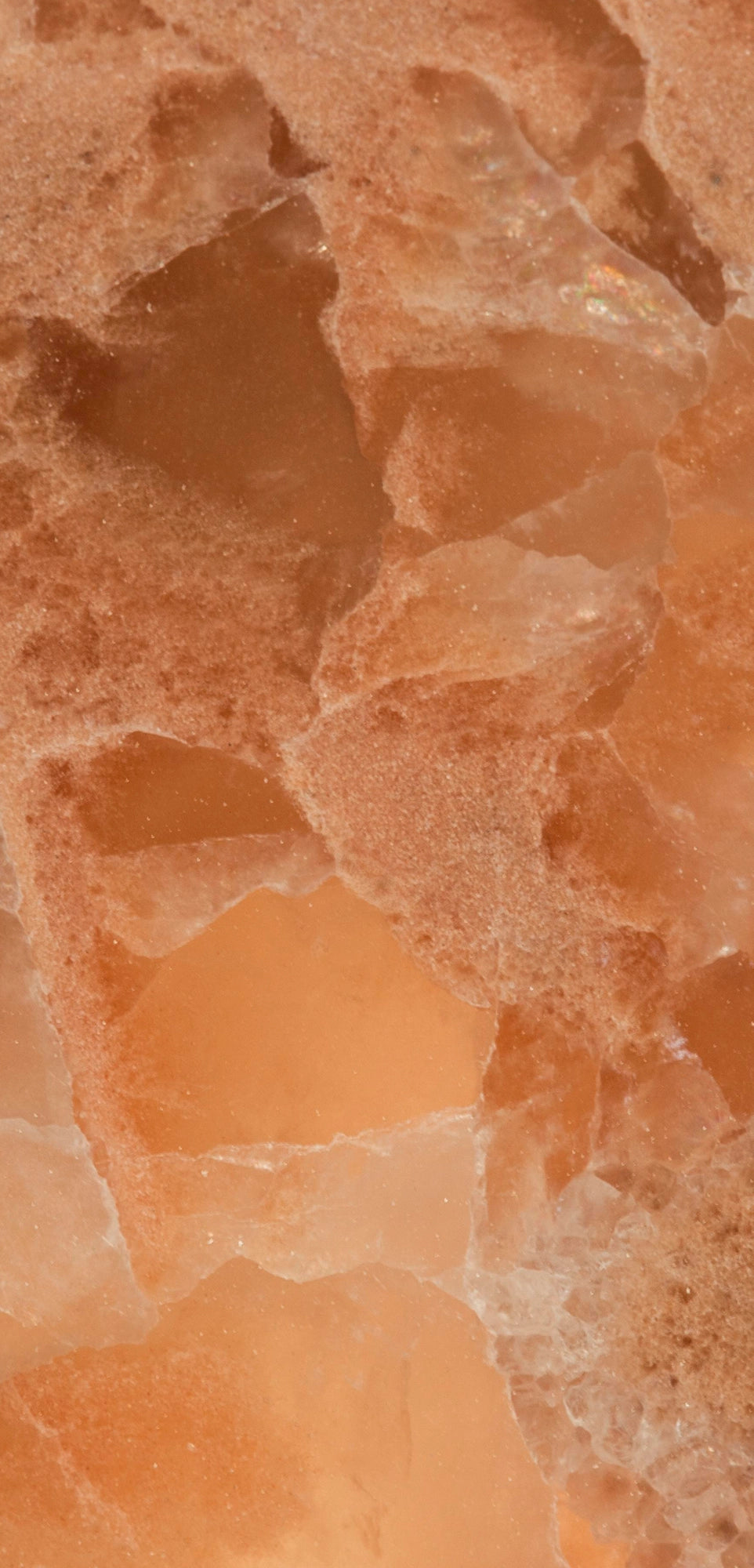 FX‑136 Coral Sands Marble flexible marble panel showcasing warm coral‑orange onyx clusters with translucent crystal formations and sandy-textured layers, by Dunya Home Design.