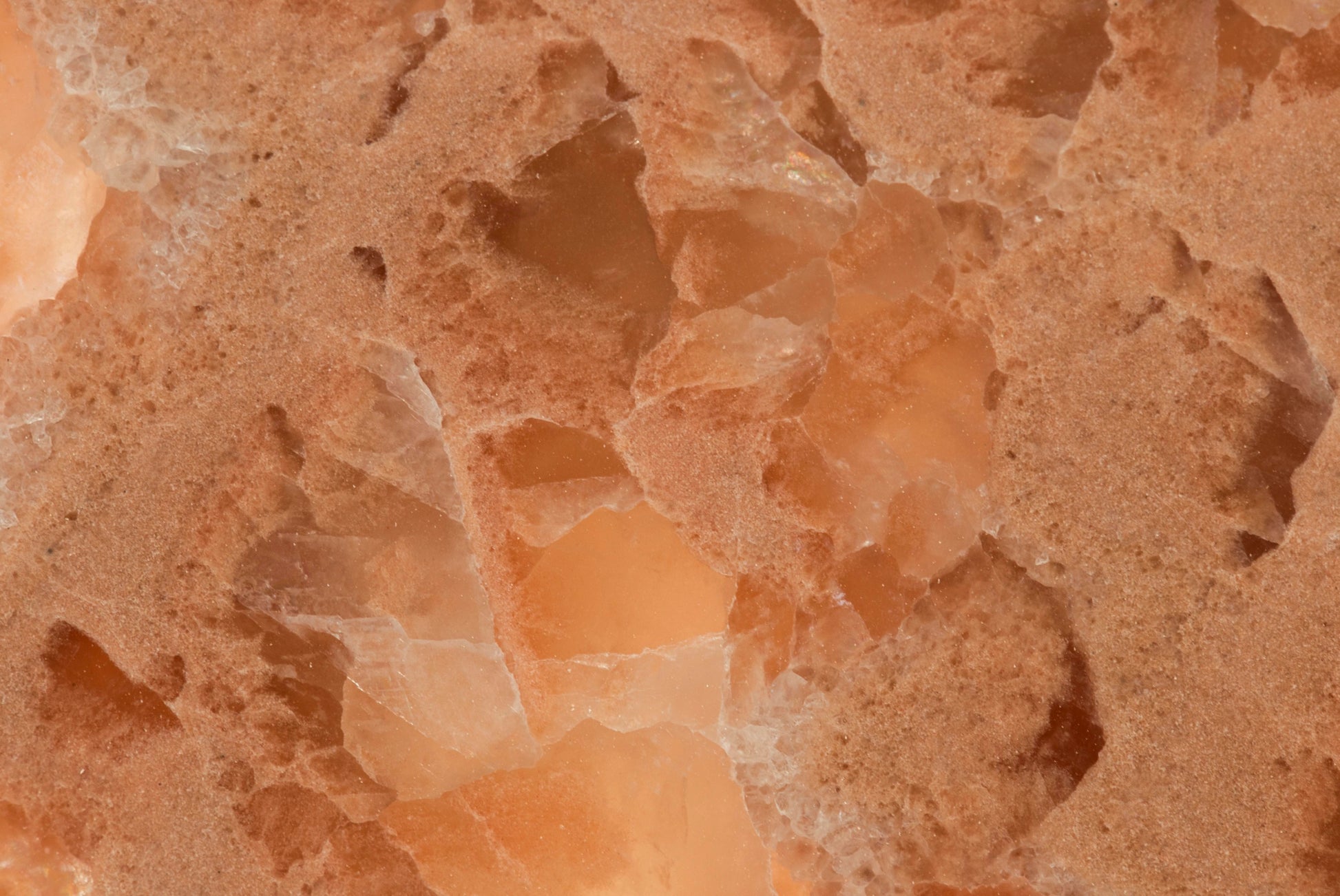 FX‑136 Coral Sands Marble flexible marble panel showcasing warm coral‑orange onyx clusters with translucent crystal formations and sandy-textured layers, by Dunya Home Design.
