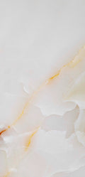 FX‑137 Golden Dawn Marble flexible marble panel showcasing luminous white and pale cream onyx layers with gentle golden-yellow highlights and soft translucent textures, by Dunya Home Design.