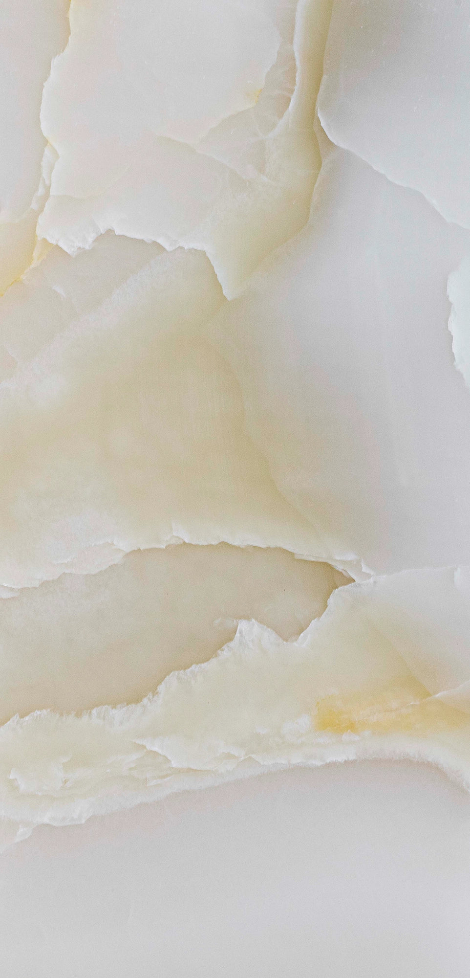 FX‑137 Golden Dawn Marble flexible marble panel showcasing luminous white and pale cream onyx layers with gentle golden-yellow highlights and soft translucent textures, by Dunya Home Design.