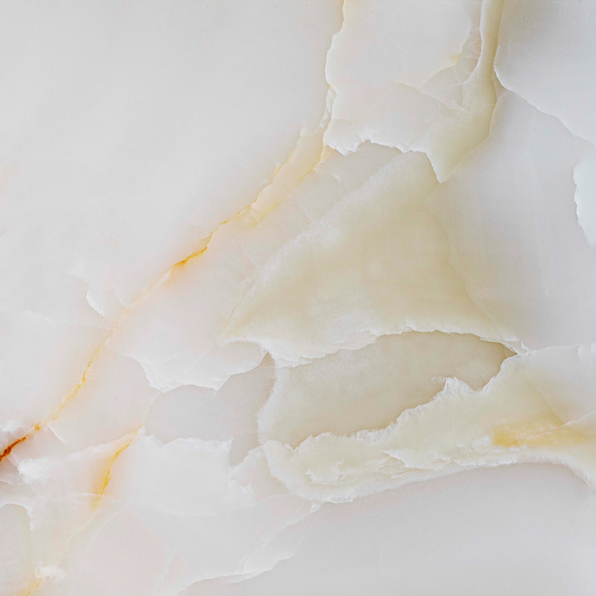 FX‑137 Golden Dawn Marble flexible marble panel showcasing luminous white and pale cream onyx layers with gentle golden-yellow highlights and soft translucent textures, by Dunya Home Design.