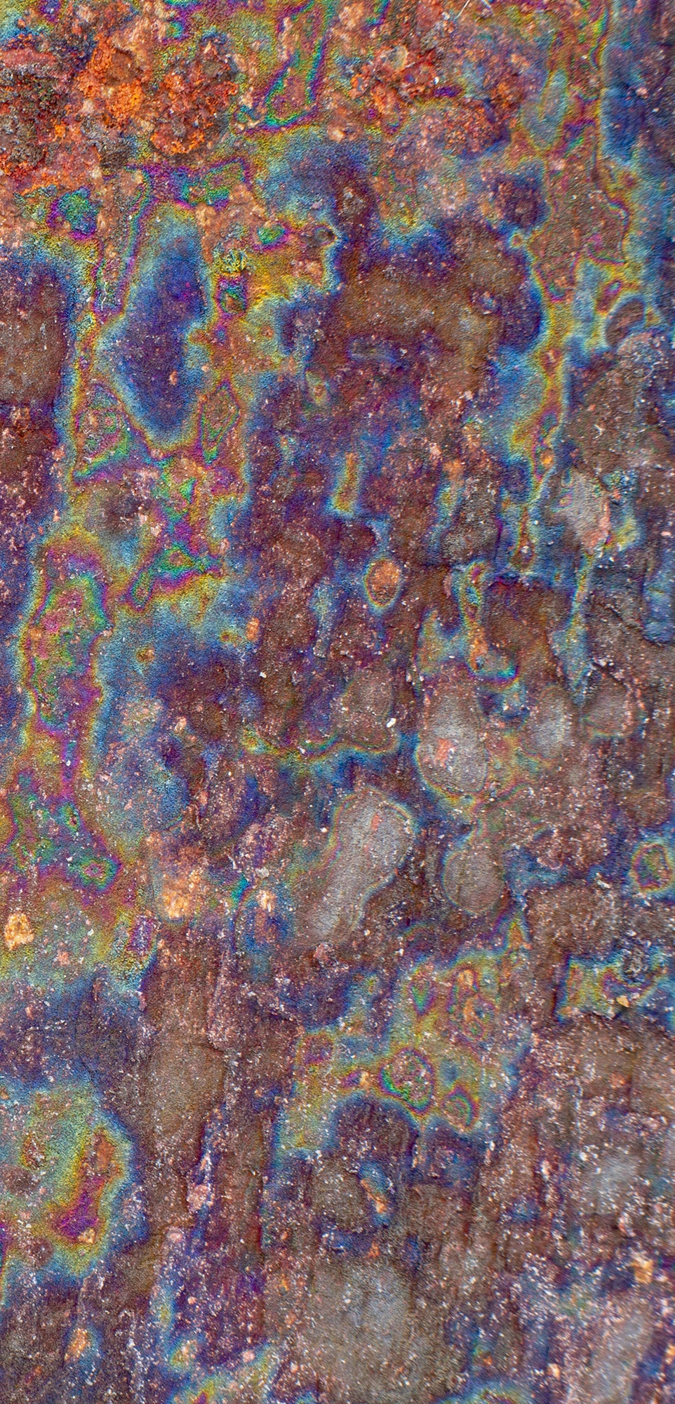FX‑138 Prism Patina Marble flexible marble panel showcasing iridescent rainbow patina effects with mottled rust and metallic textures, by Dunya Home Design.
