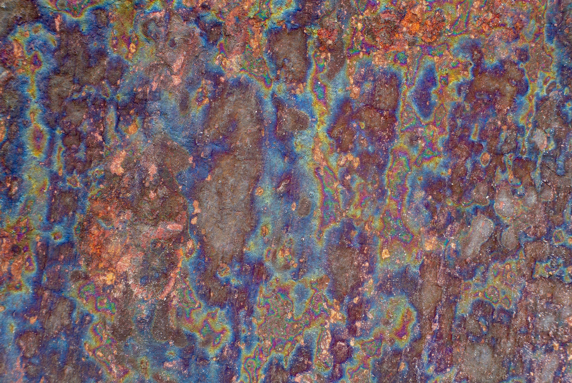 FX‑138 Prism Patina Marble flexible marble panel showcasing iridescent rainbow patina effects with mottled rust and metallic textures, by Dunya Home Design.