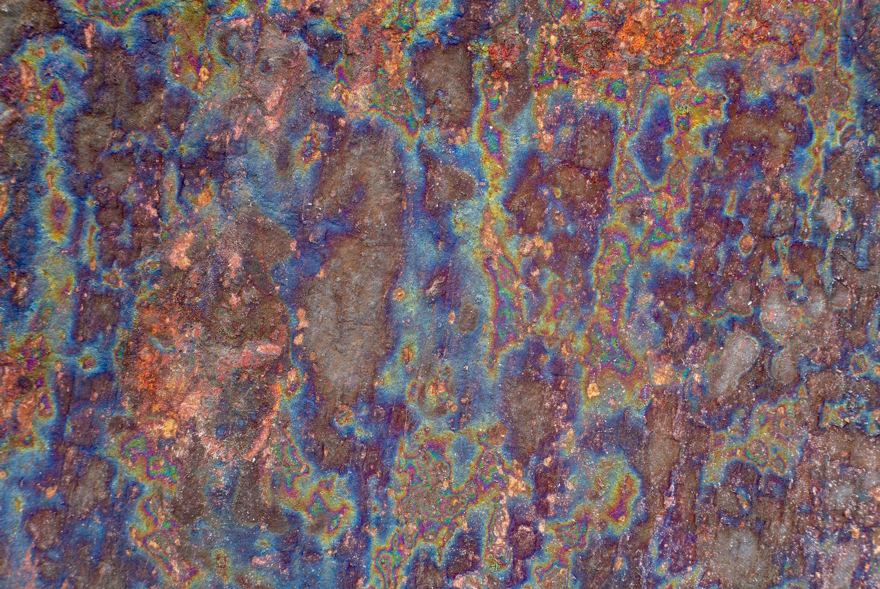 FX‑138 Prism Patina Marble flexible marble panel showcasing iridescent rainbow patina effects with mottled rust and metallic textures, by Dunya Home Design.