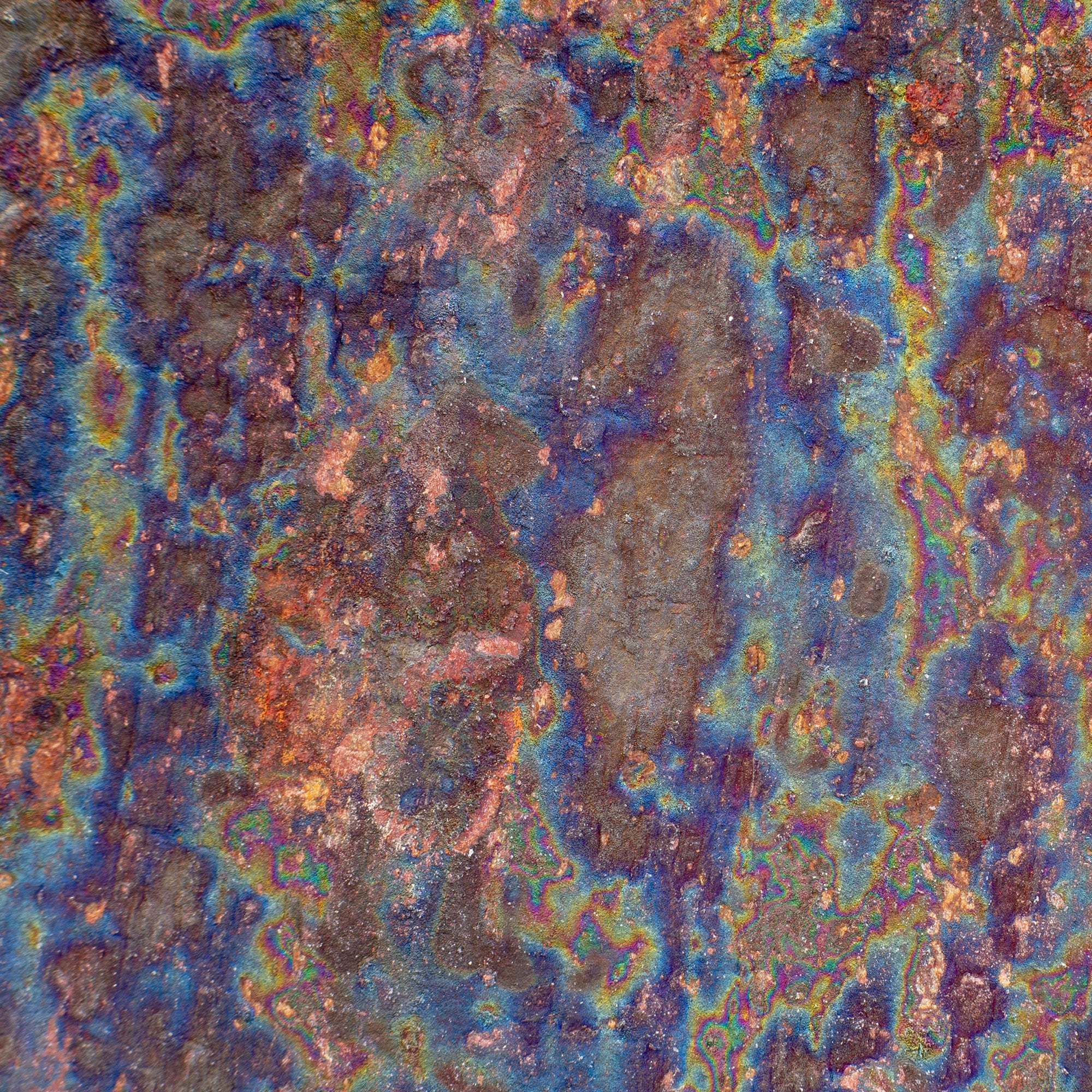 FX‑138 Prism Patina Marble flexible marble panel showcasing iridescent rainbow patina effects with mottled rust and metallic textures, by Dunya Home Design.