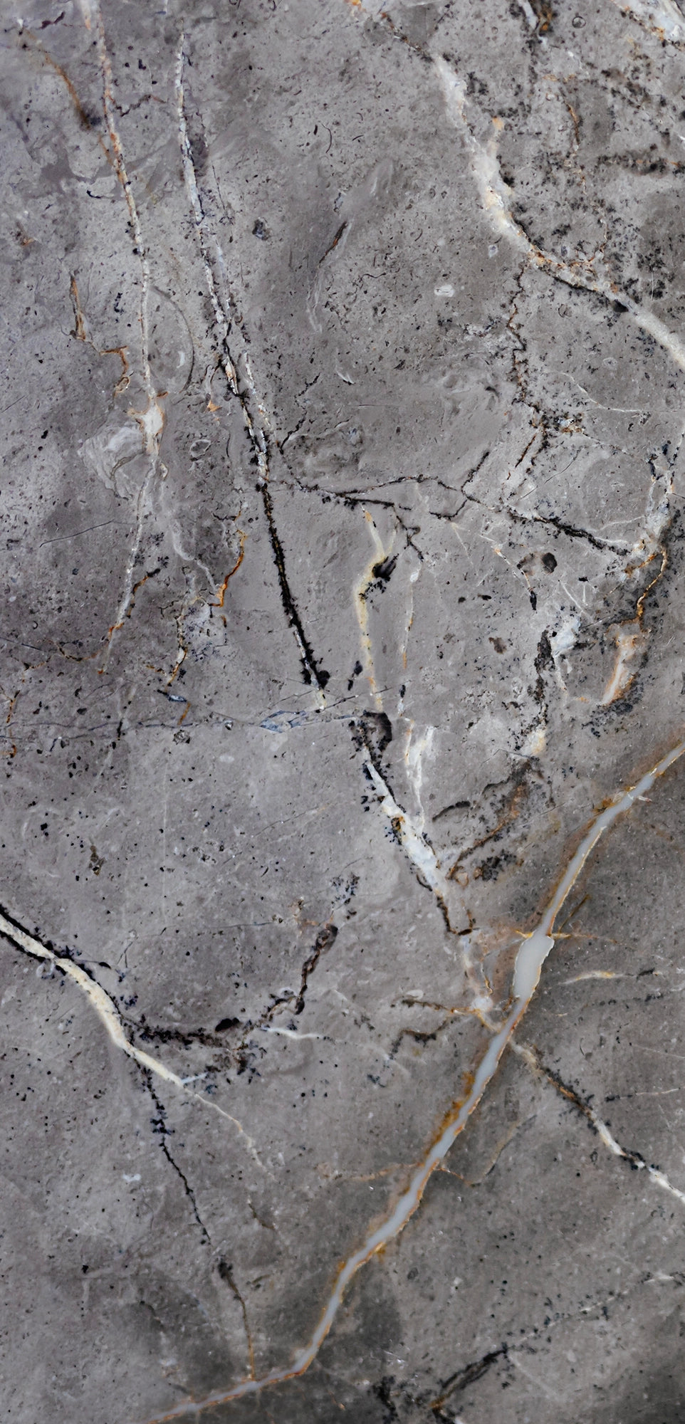 FX‑142 Iron Vein Marble flexible marble panel featuring a cool mid‑grey base streaked with bold white and rust‑orange veins, accented by fine iron‑speckled textures for an industrial yet elegant look, by Dunya Home Design.