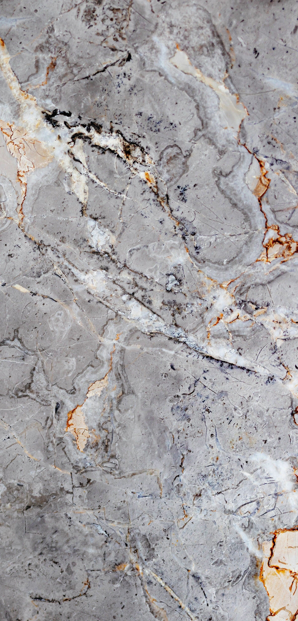FX‑142 Iron Vein Marble flexible marble panel featuring a cool mid‑grey base streaked with bold white and rust‑orange veins, accented by fine iron‑speckled textures for an industrial yet elegant look, by Dunya Home Design.
