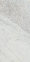 “FX‑149 Arctic Drift Marble” flexible panel by Dunya Home Design: a cool white marble ground shot through with soft, brush‑stroke swaths of pale gray‑blue and taupe that fan out diagonally, accented by fine, delicate hairline veins of warm gold.