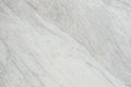 “FX‑149 Arctic Drift Marble” flexible panel by Dunya Home Design: a cool white marble ground shot through with soft, brush‑stroke swaths of pale gray‑blue and taupe that fan out diagonally, accented by fine, delicate hairline veins of warm gold.