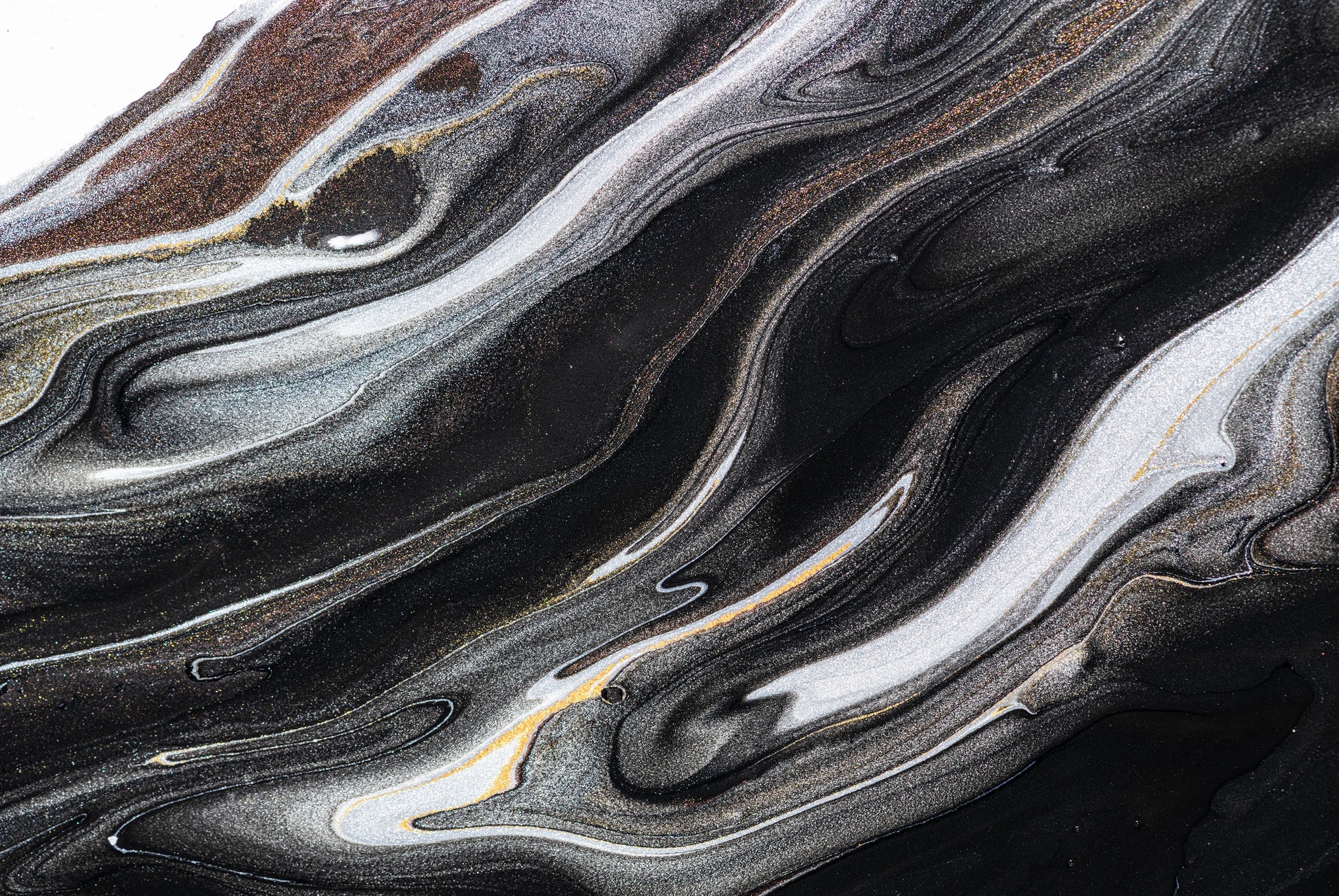 “FX‑152 Obsidian Flow Marble” flexible panel by Dunya Home Design: a dynamic, fluid pattern of swirling deep black base streaked with metallic silver and warm copper‑gold accents, creating a glossy, marble‑like surface with glittering, flowing veins.