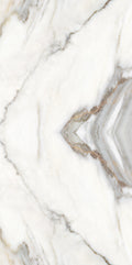 FX ‑ 180 Auric Prism Calacatta Marble flexible marble panel showcasing a luminous white Calacatta background book‑matched into a central diamond prism motif with soft gray and warm gold veins radiating outward like molten metal highlights, by Dunya Home Design.
