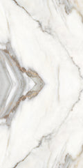 FX ‑ 180 Auric Prism Calacatta Marble flexible marble panel showcasing a luminous white Calacatta background book‑matched into a central diamond prism motif with soft gray and warm gold veins radiating outward like molten metal highlights, by Dunya Home Design.

