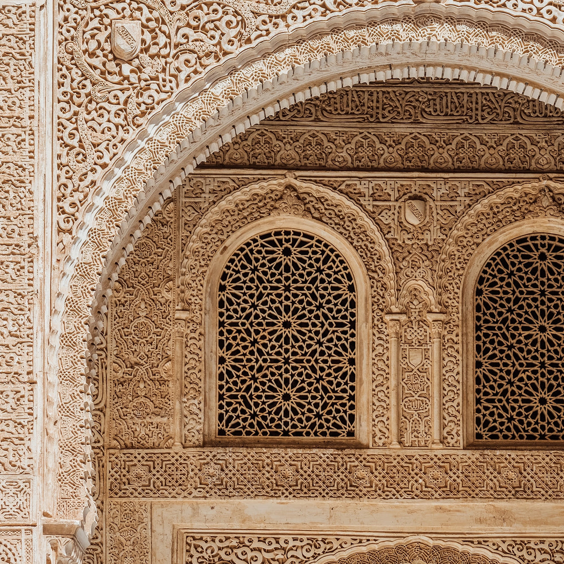 FX‑184 Arabesque Filigree Marble flexible marble panel showcasing a symmetrical Moorish arch motif filled with intricate, lace‑like arabesque carving in warm sandstone‑beige hues, by Dunya Home Design.

