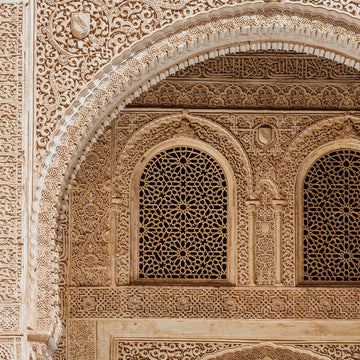 FX‑184 Arabesque Filigree Marble flexible marble panel showcasing a symmetrical Moorish arch motif filled with intricate, lace‑like arabesque carving in warm sandstone‑beige hues, by Dunya Home Design.
