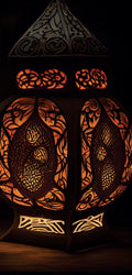 Marble mural of ornate antique lanterns glowing with warm light, featuring intricate carved patterns in a rich, ambient setting