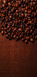 Marble mural of dark textured surface surrounded by coffee beans and espresso-making tools, evoking rich coffee tones