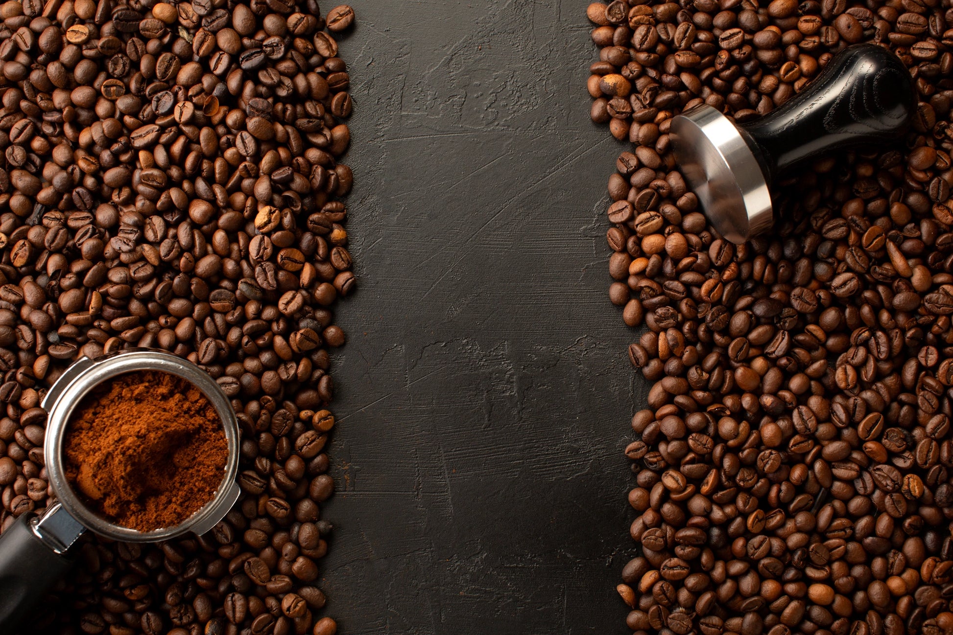 Marble mural of dark textured surface surrounded by coffee beans and espresso-making tools, evoking rich coffee tones