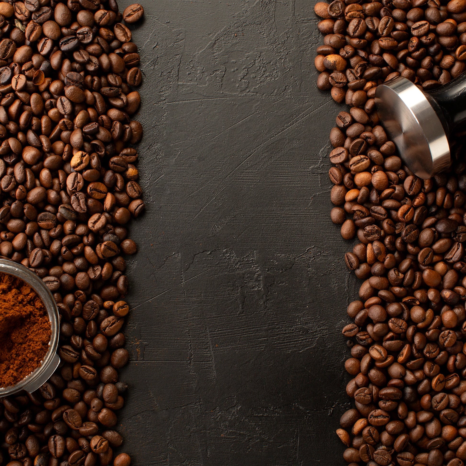 Marble mural of dark textured surface surrounded by coffee beans and espresso-making tools, evoking rich coffee tones